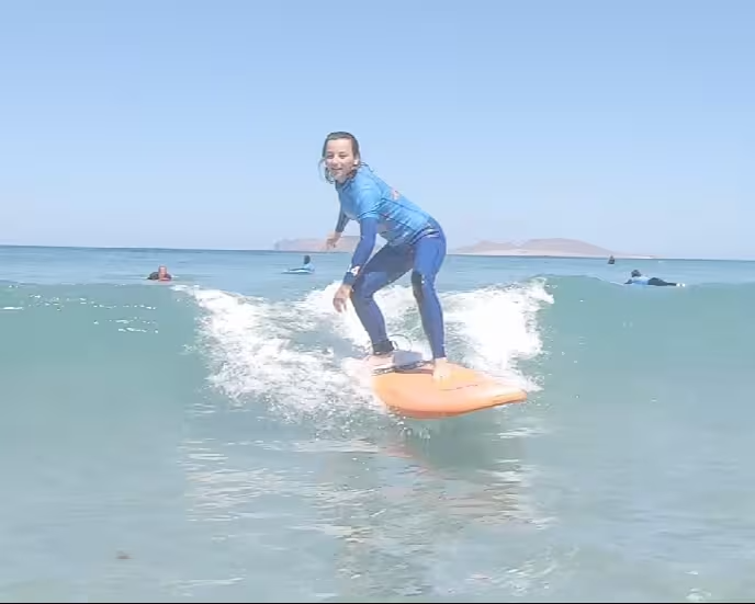 A intermediate to advanced surfer rides a fun-sized green wave.